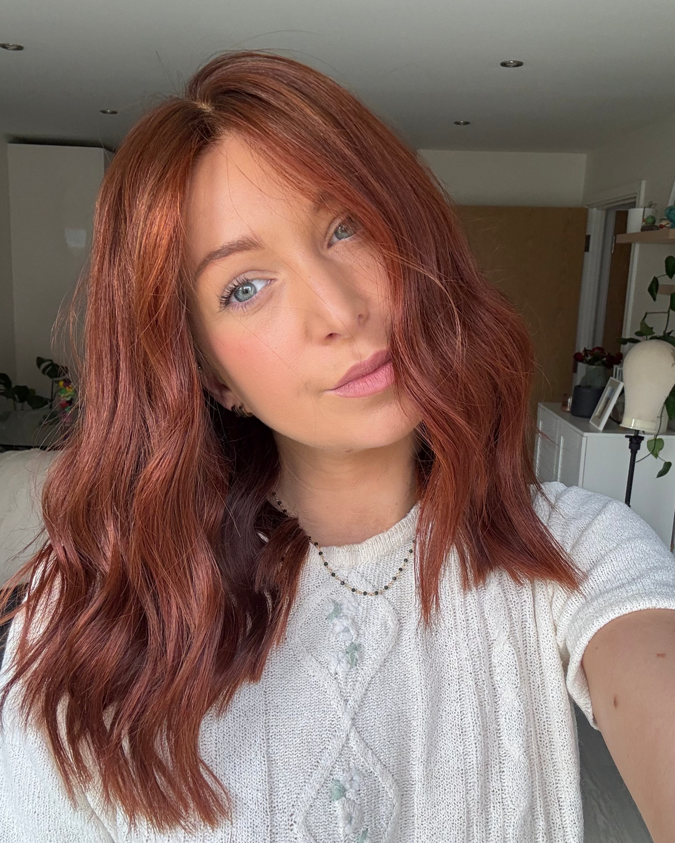 Woman with red hair in a casual indoor setting